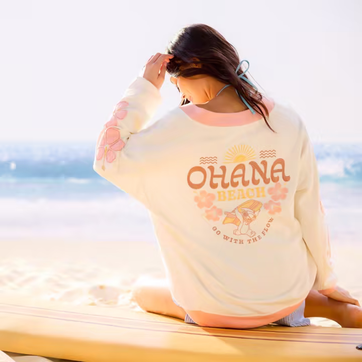 Model wearing the Stitch Surf Pullover Sweatshirt from Disney Store