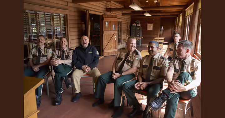 The Super Troopers and Captain O'Hagan sit together inside their Vermont station
