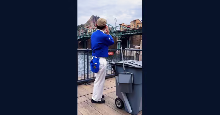 Tokyo DisneySea custodial Cast Member beside a cleaning cart at Mediterranean Harbor
