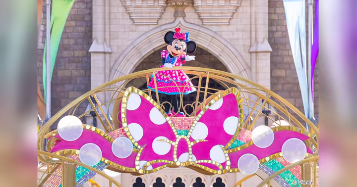 Minnie Mouse aboard a pink parade float at Tokyo Disneyland