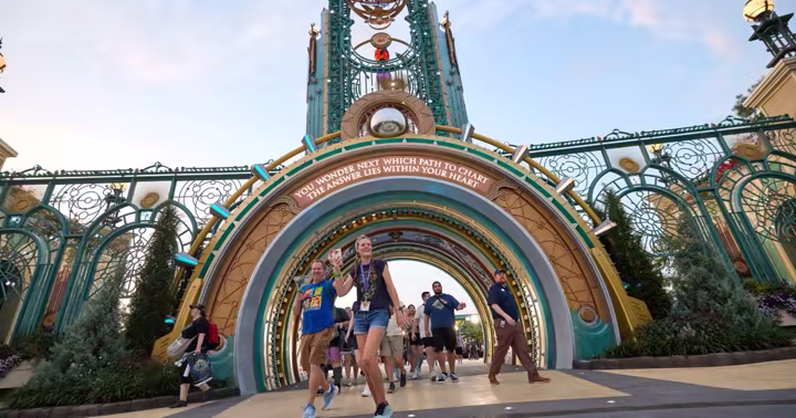 Guests entering Epic Universe beneath the Celestial Park entrance