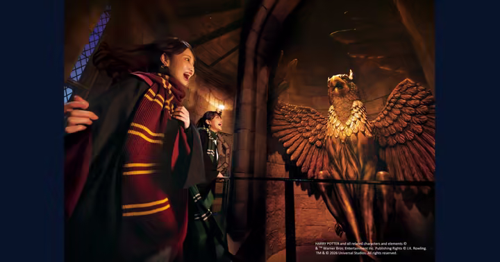 Guests inside Hogwarts Castle near the griffin statue at Universal Studios Japan