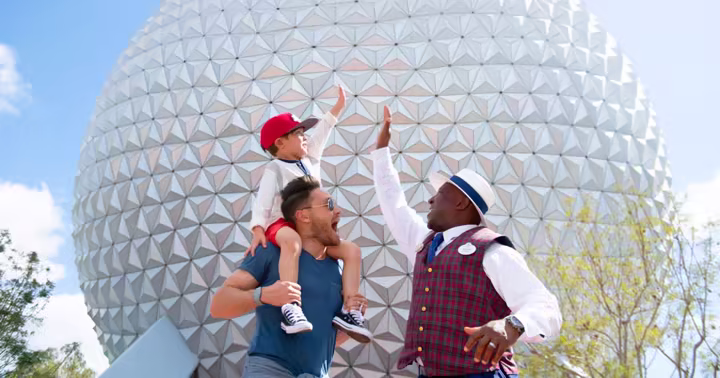 Walt Disney World VIP Tour Guide greeting a family in front of Spaceship Earth