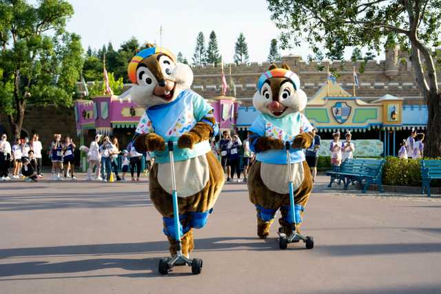 Chip and Dale ride scooters during a Hong Kong Disneyland race