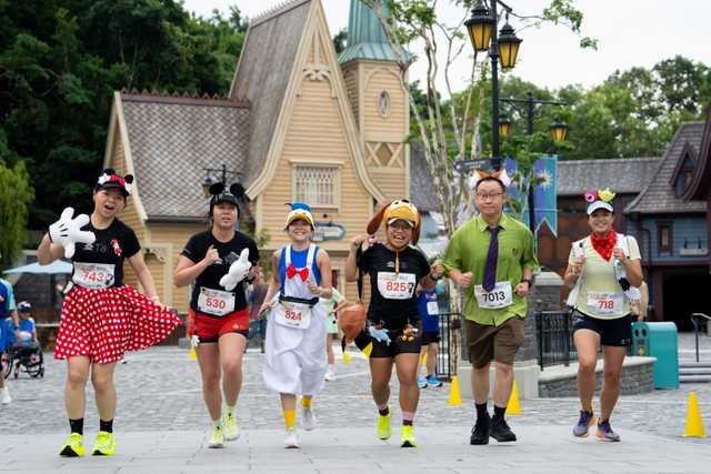 Runners wear Disney character costumes at Hong Kong Disneyland