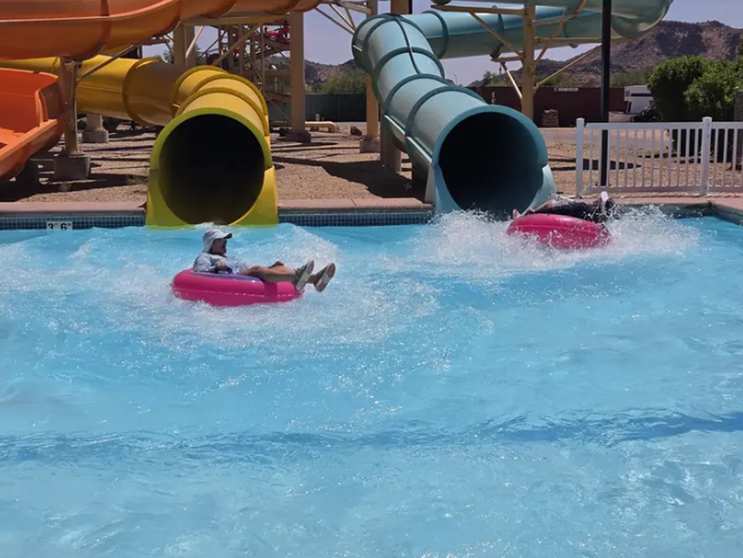 Guests riding tubes through Hurricane Harbor Phoenix water slides