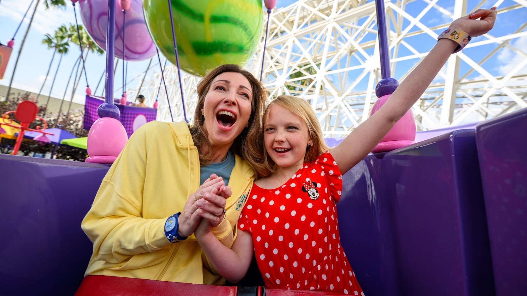A mother and daughter ride Inside Out Emotional Whirlwind at Disney California Adventure