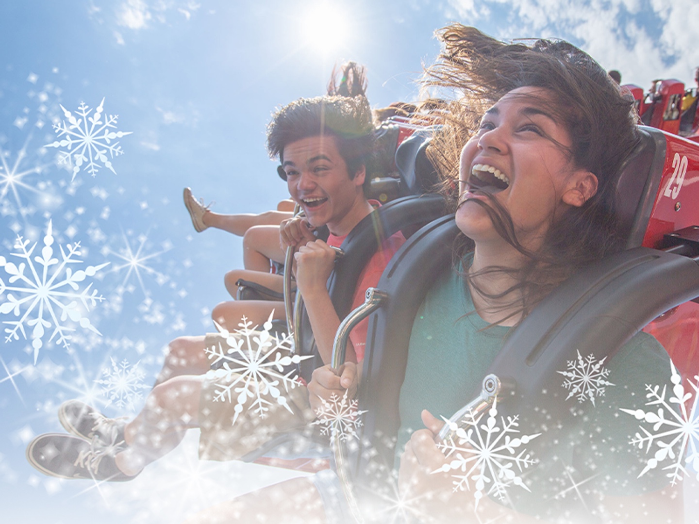 Kings Dominion riders surrounded by Christmas in July snowflakes