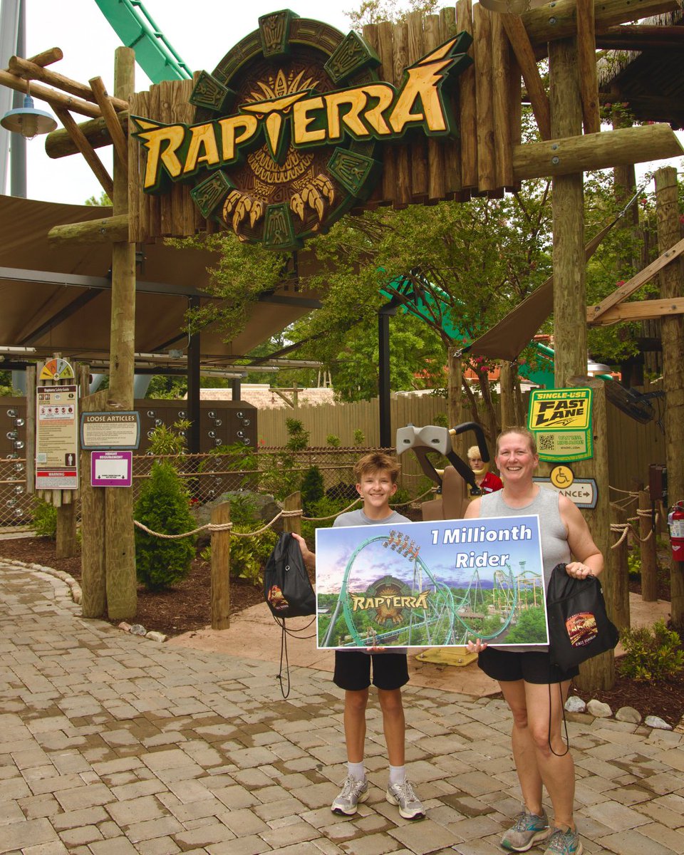 Rapterra guests pose with a one-millionth-rider sign at Kings Dominion