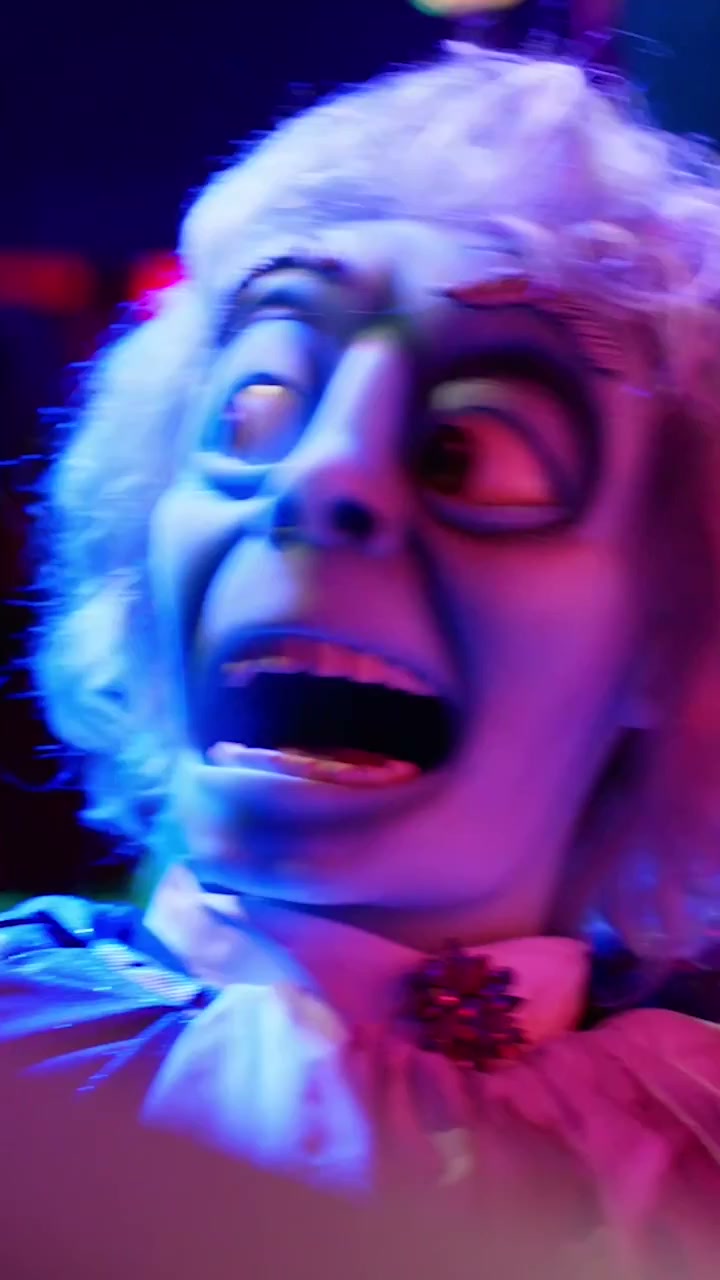 A Phantom Theater character appears in blue and magenta light at Kings Island