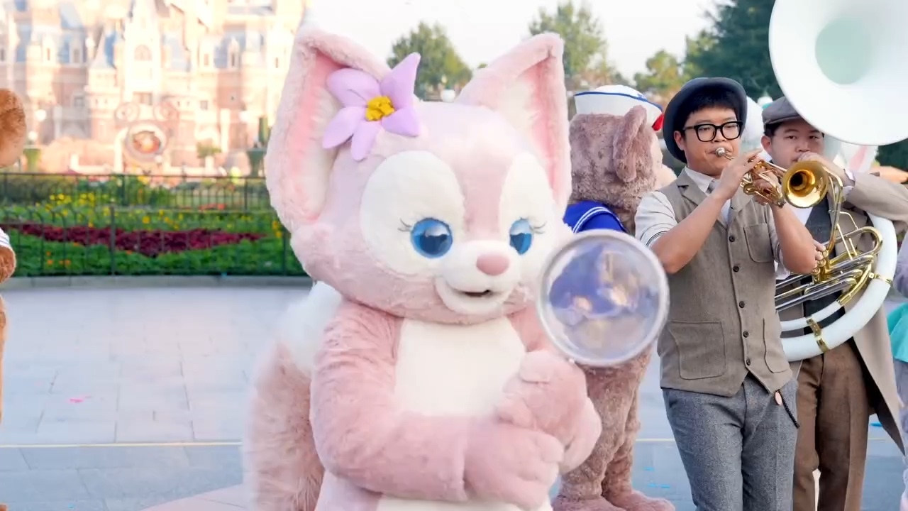 LinaBell walks in front of Enchanted Storybook Castle during an official Shanghai Disney Resort anniversary video