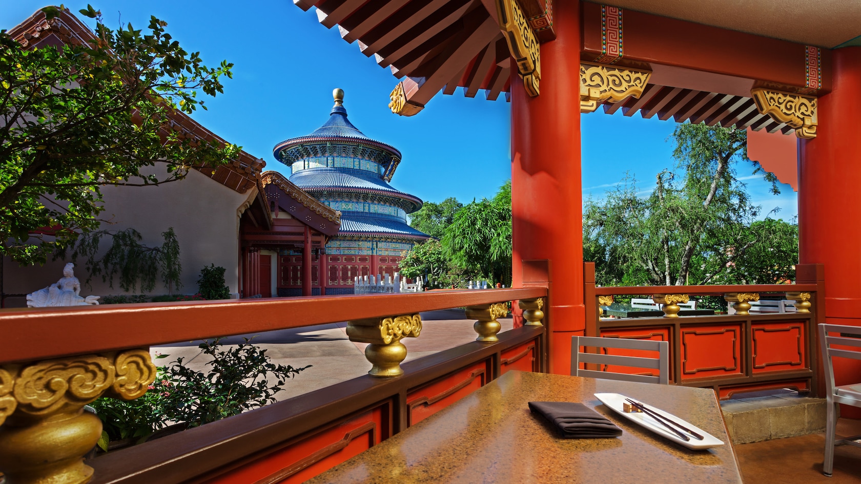 Covered dining area at Lotus Blossom Café with the Temple of Heaven in the background