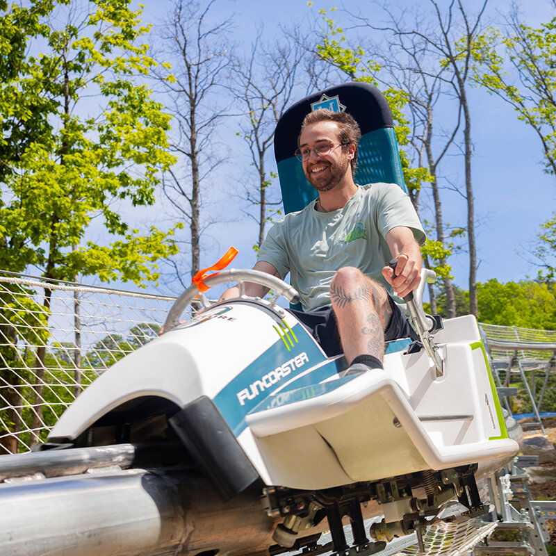 A rider on the Mountain Mayhem alpine coaster at Massanutten Resort