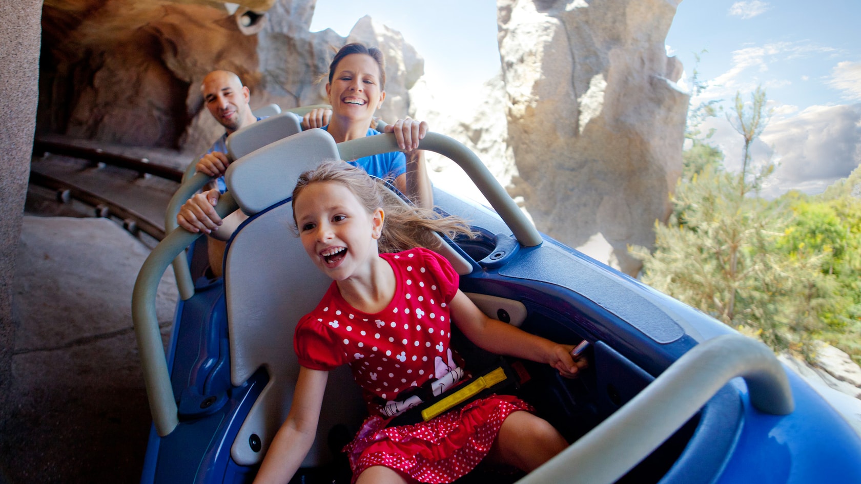 A family rides Matterhorn Bobsleds at Disneyland Park