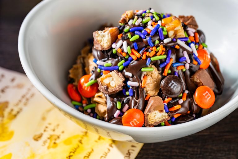 Candy Bowl Sundae: Vanilla soft-serve topped with chocolate cone dip, SNICKERS bar pieces, TWIX cookie bar pieces, and M&M’S Milk Chocolate Candies Halloween Blend (Available during Mickey’s Not-So-Scary Halloween Party only)
