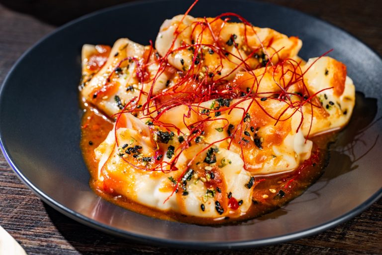 Doom Buggy Dumplings: Chicken dumplings with red miso gochujang sauce, furikake, and chili threads (New) (Available during Mickey’s Not-So-Scary Halloween Party only)
