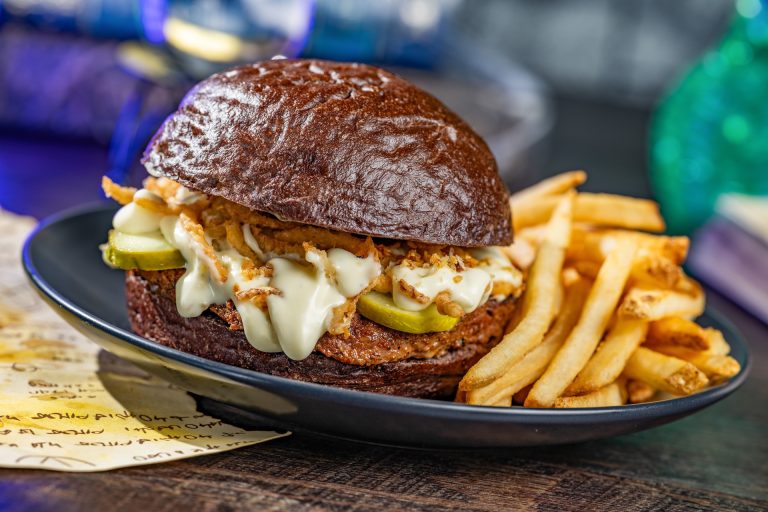 Fang-tastic Garlic Butter Burger: Angus beef with Boursin and brie fondue and garlic pickles on a toasted black bun. Served with french fries (New) (Available during Mickey’s Not-So-Scary Halloween Party only)