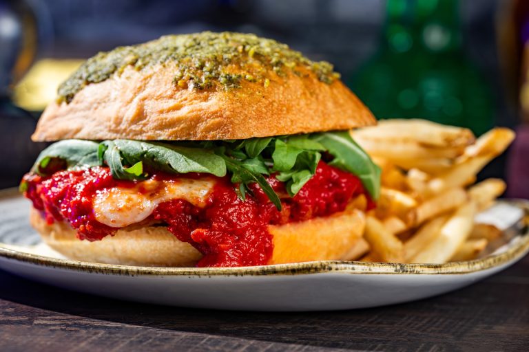 Fra Diavolo Chicken Sandwich: Fried chicken breast with fra diavolo sauce, cheese, basil pesto, and arugula on a ciabatta bun served with french fries (New) (Available during Mickey’s Not-So-Scary Halloween Party only)