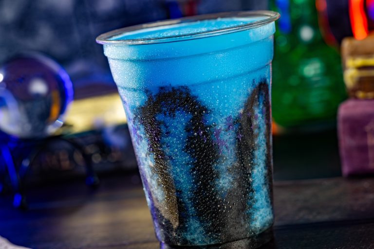 Ghoulish Blue Raspberry Slushy: Fanta Blue Raspberry Slushy with black vanilla drizzle (Non-alcoholic) (Available during regular park hours and Mickey’s Not-So-Scary Halloween Party)