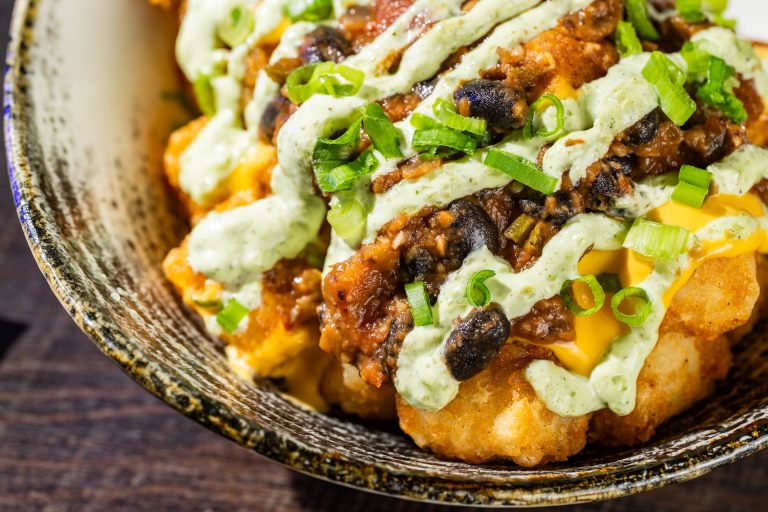 Haunting Jalapeño Tots: Tots topped with plant-based black bean chili, cheddar sauce, and jalapeño sauce (Available during Mickey’s Not-So-Scary Halloween Party only)