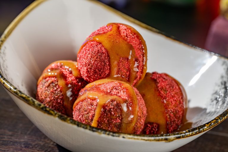 Not-So-Poison Apple Doughnuts rolled in apple cider sugar and drizzled with caramel sauce (Available during Mickey’s Not-So-Scary Halloween Party only)