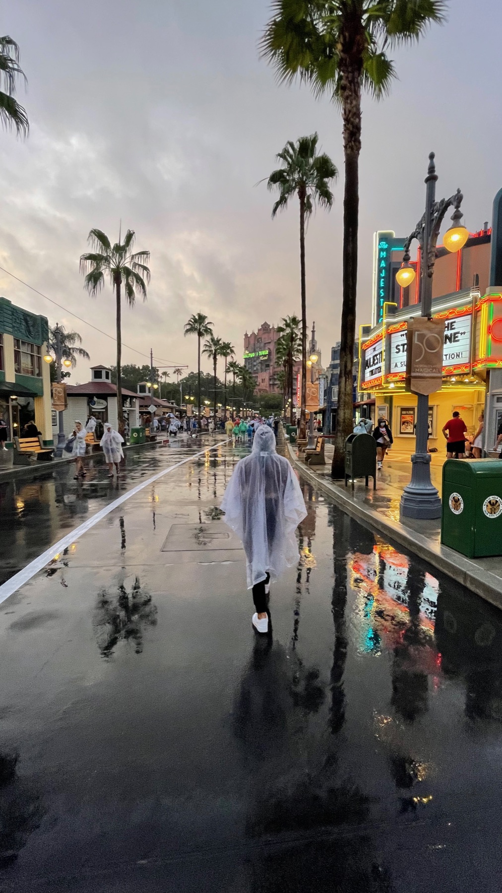 Rain falls on Hollywood Boulevard at Disney’s Hollywood Studios as guests walk in ponchos