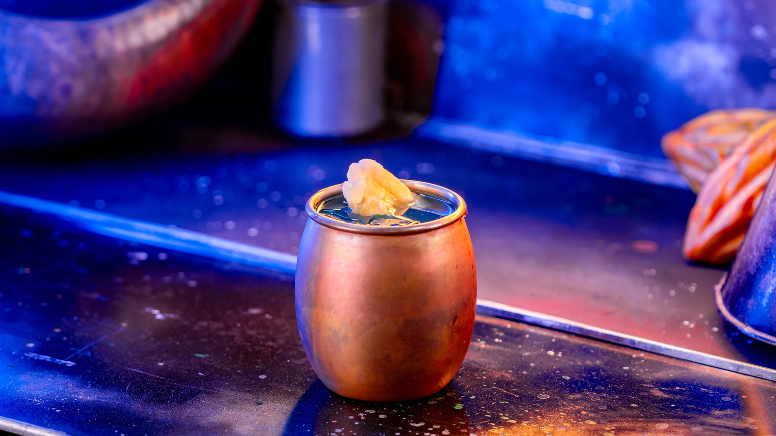 Blue Alderaanian Fizz cocktail in a metal cup at Oga’s Cantina