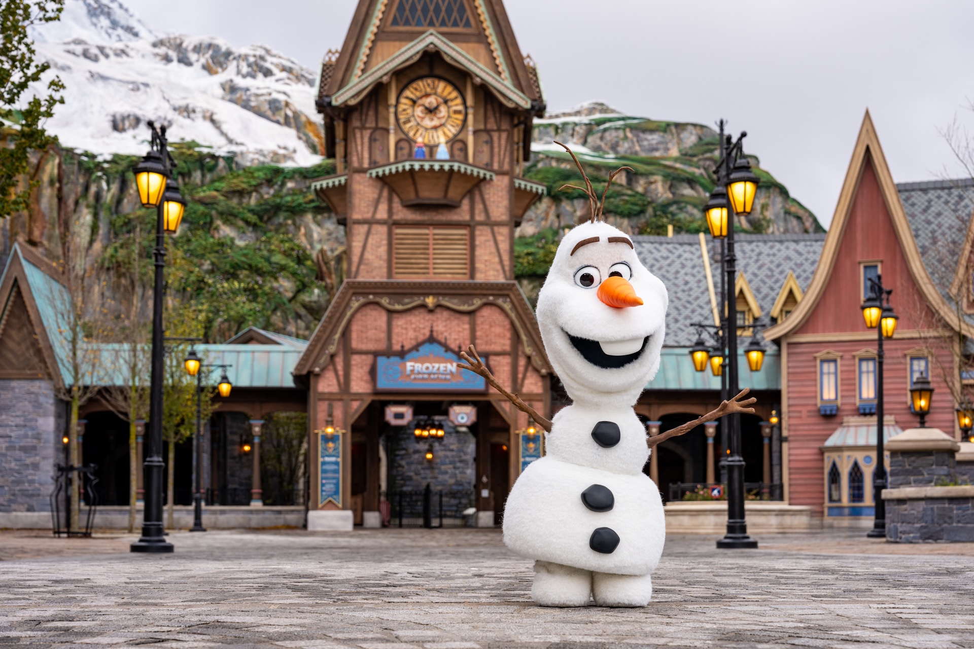 Disney’s robotic Olaf character standing in front of a Frozen-themed village, shown as an archival image