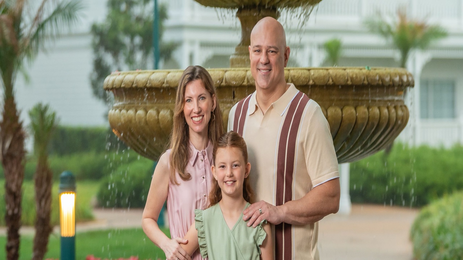 A family posing near a Disney resort fountain at Walt Disney World