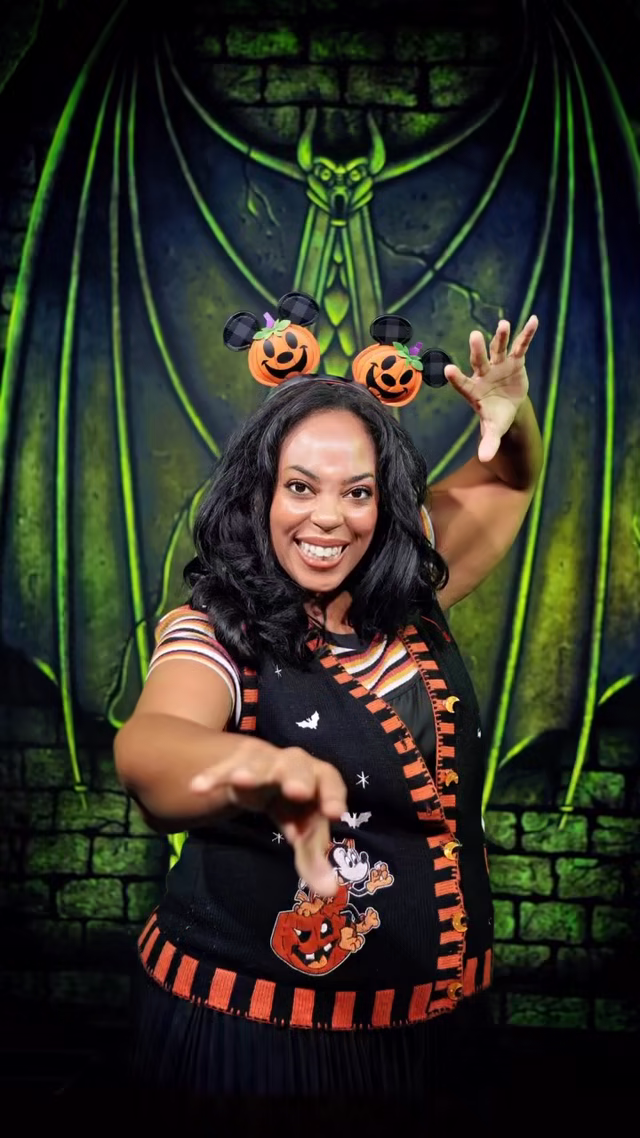 A guest poses inside one of the Disney Villains lairs at the Disney Springs PhotoPass Studio