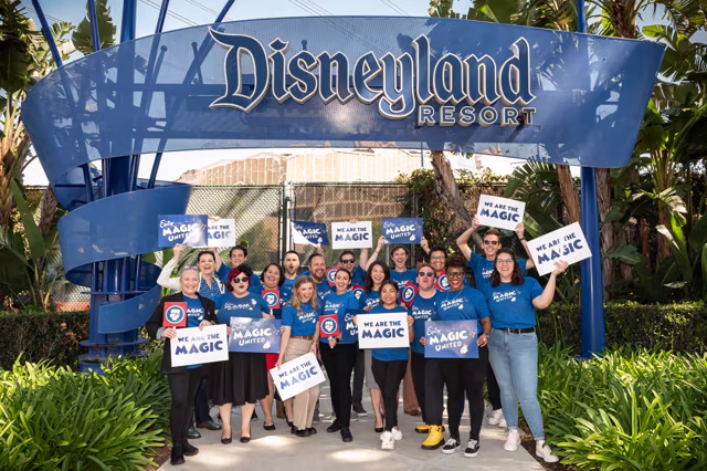 Magic United supporters stand beneath the Disneyland Resort sign during the 2024 union campaign