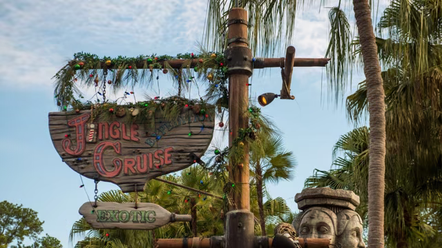 The Jingle Cruise sign decorated with holiday garland at Magic Kingdom