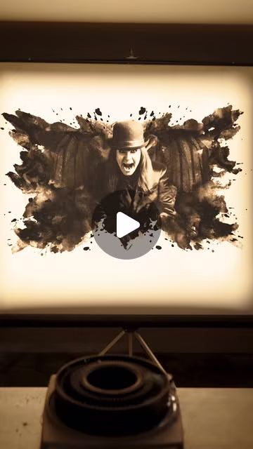 A projector displays a dark illustrated figure in a bare room in a Halloween Horror Nights teaser
