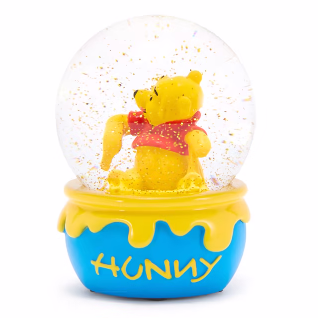 Winnie the Pooh inside a glass snow globe on a blue honey-pot base