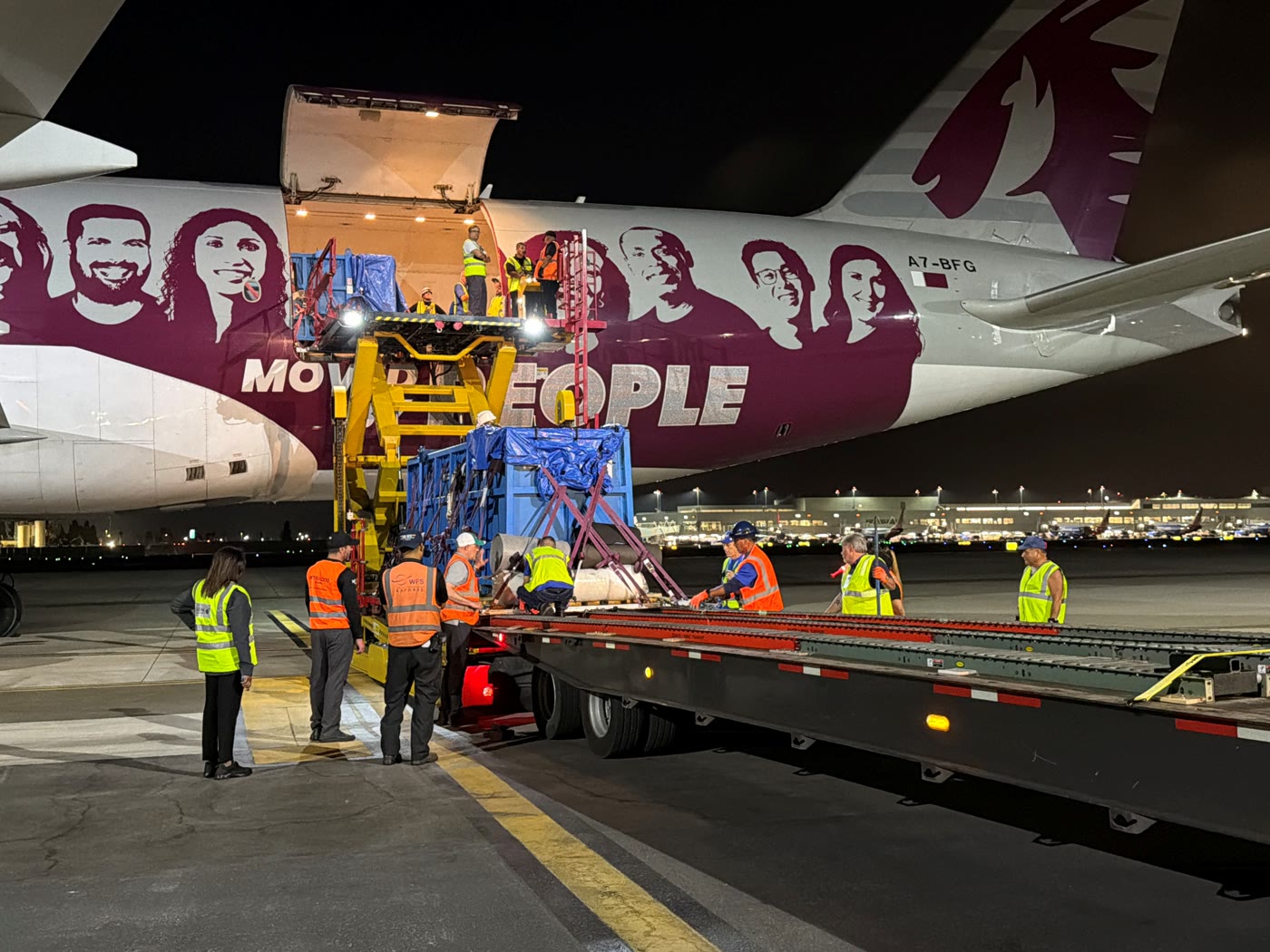 A Qatar Airways aircraft appears beside the beluga transport operation