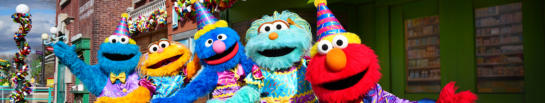 Cookie Monster, Zoe, Grover, Rosita and Elmo in birthday outfits