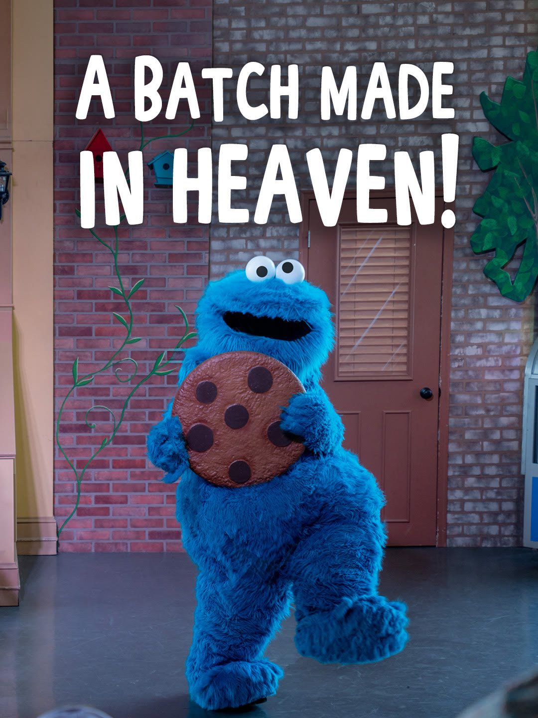 Cookie Monster holds a giant chocolate chip cookie at Sesame Place Philadelphia