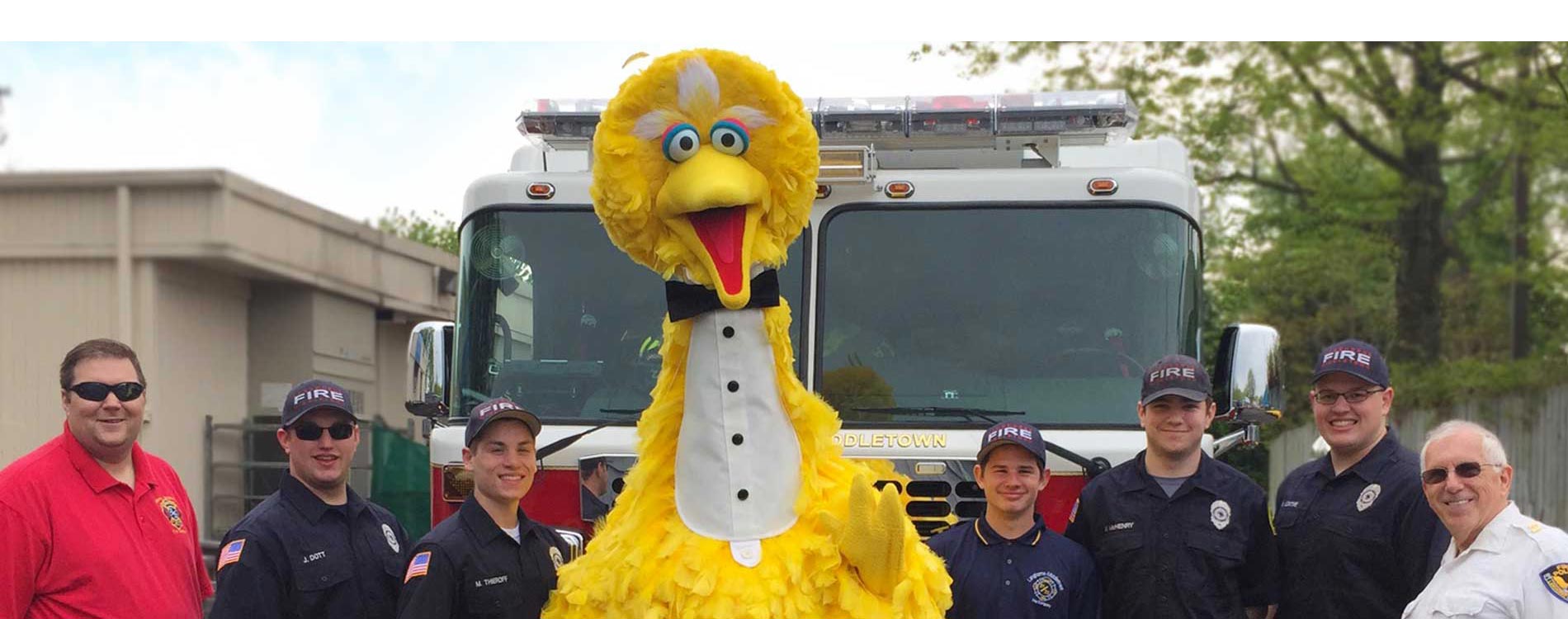 Big Bird stands with firefighters and other first responders at Sesame Place Philadelphia