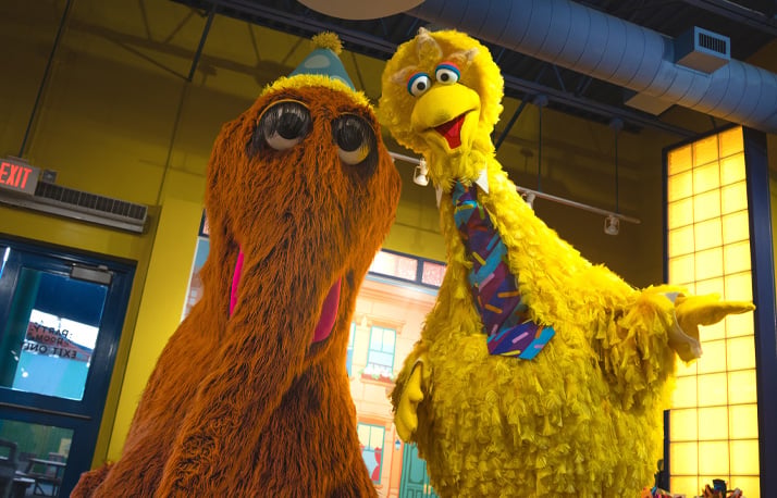 Snuffy and Big Bird sit together for birthday storytime