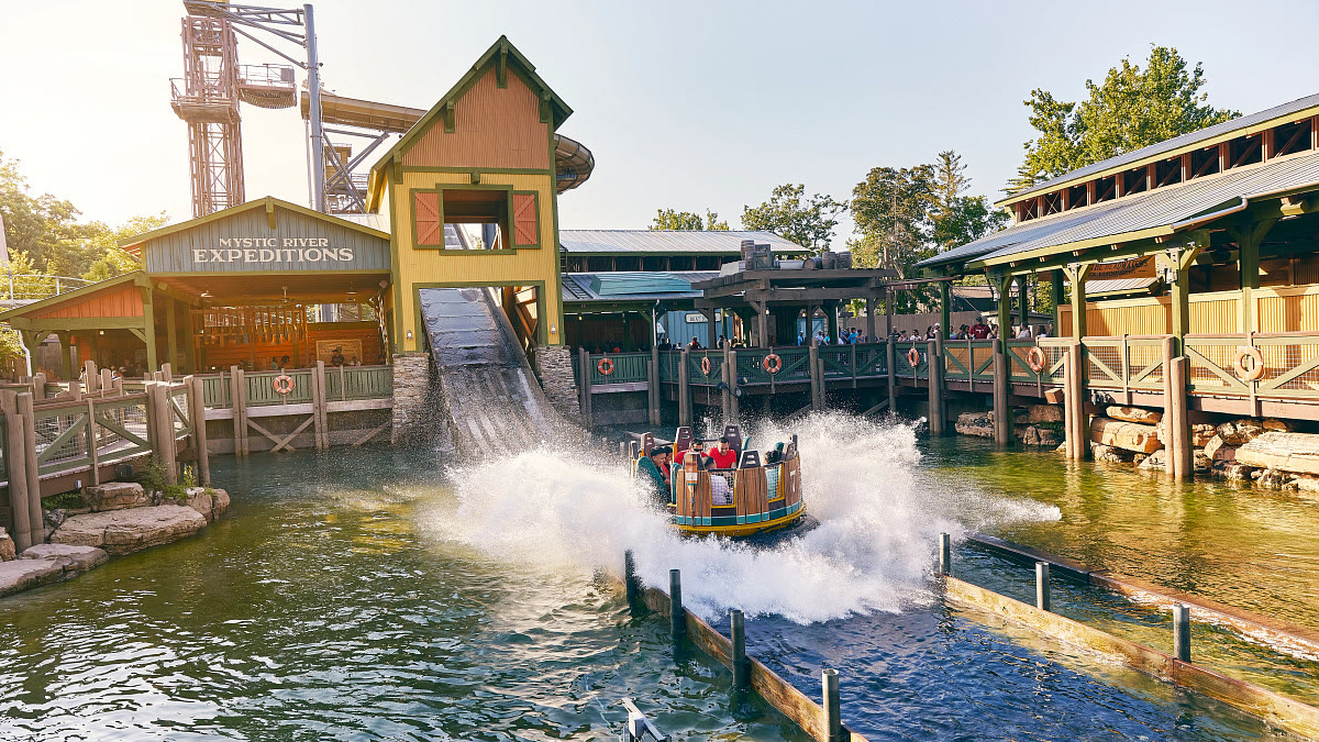 Guests ride a raft through a splashdown at Silver Dollar City