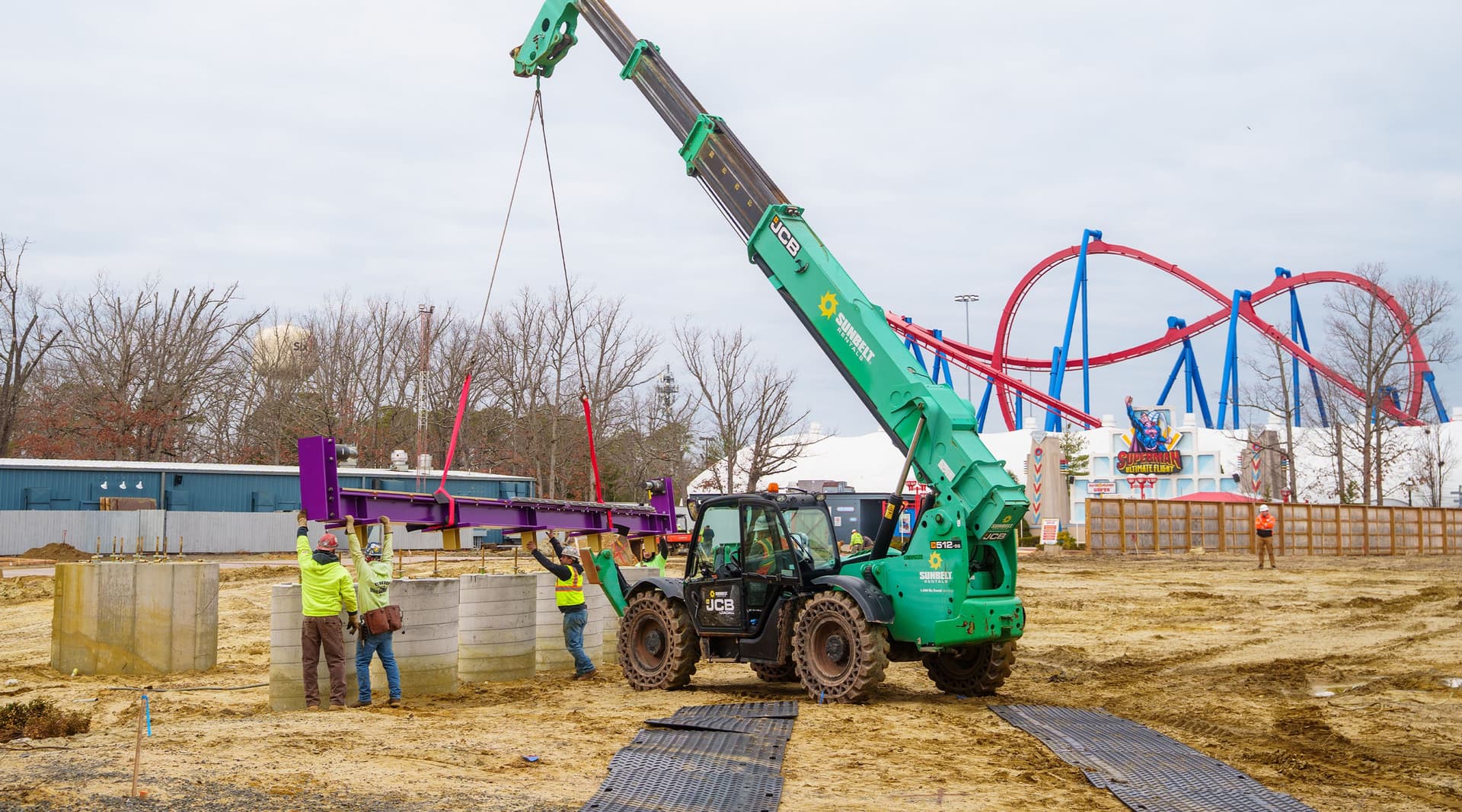 Purple roller coaster track being lifted by a crane at Six Flags Great Adventure