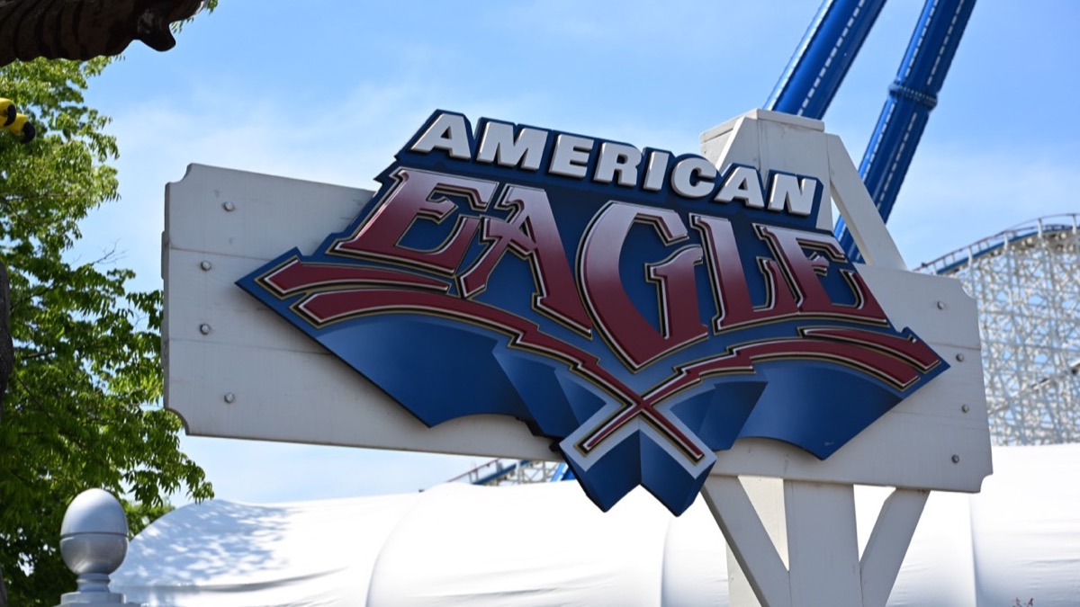 American Eagle sign at Six Flags Great America with coaster track behind it