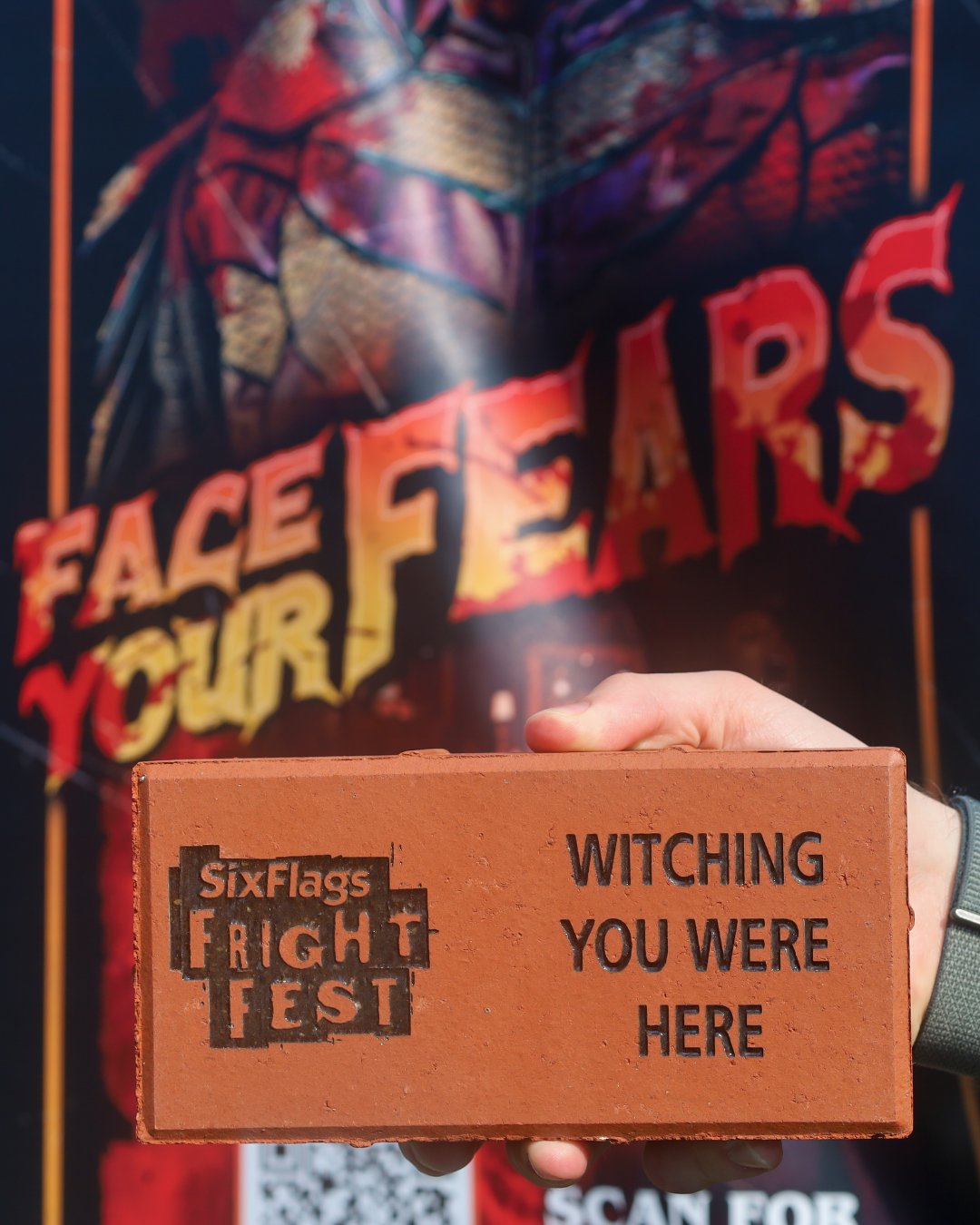 Personalized Six Flags Great America Fright Fest brick held in front of a Fright Fest sign