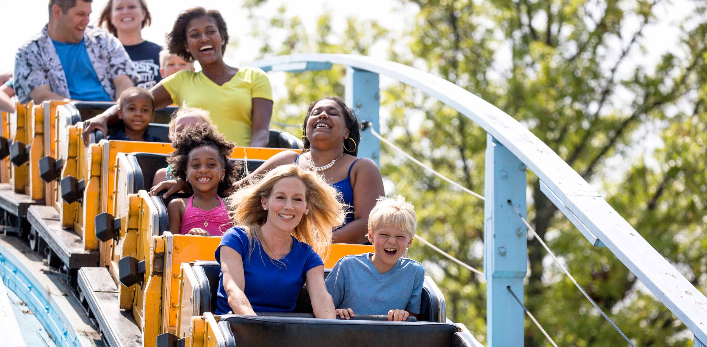 Families riding a Six Flags roller coaster in an official Pre-K Pass photo