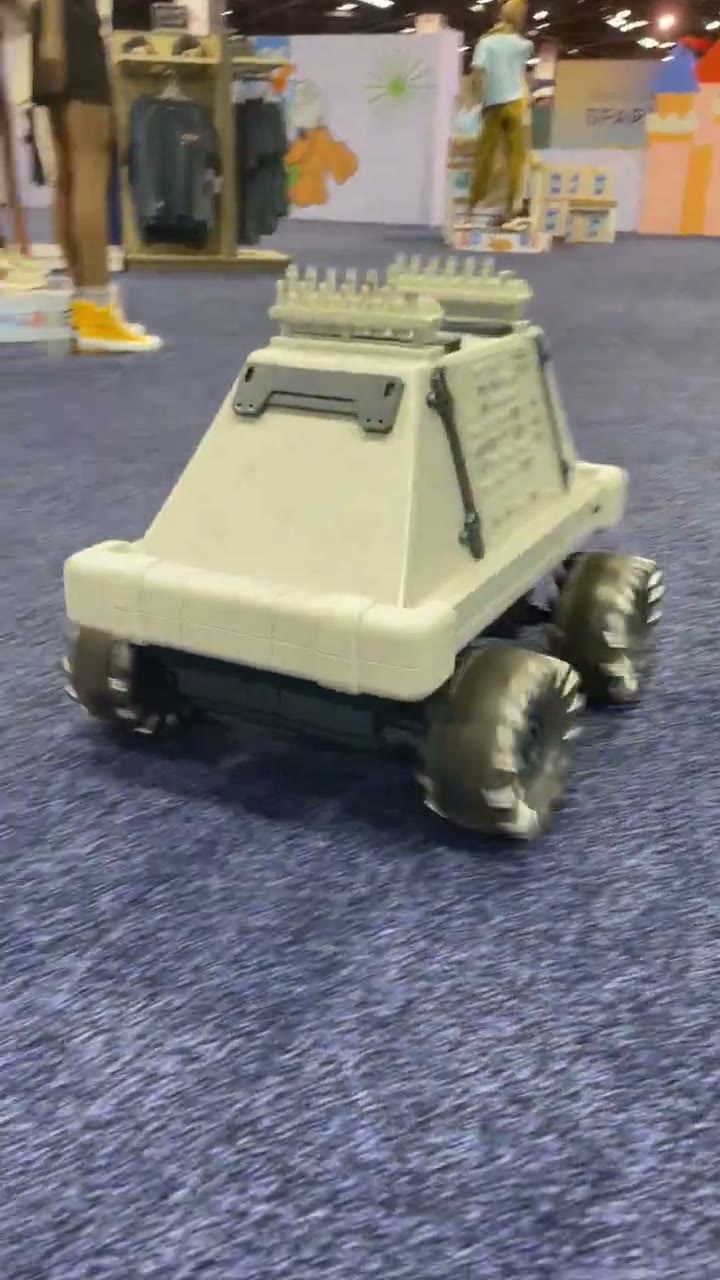 A Star Wars mouse droid rolls across the D23 show floor