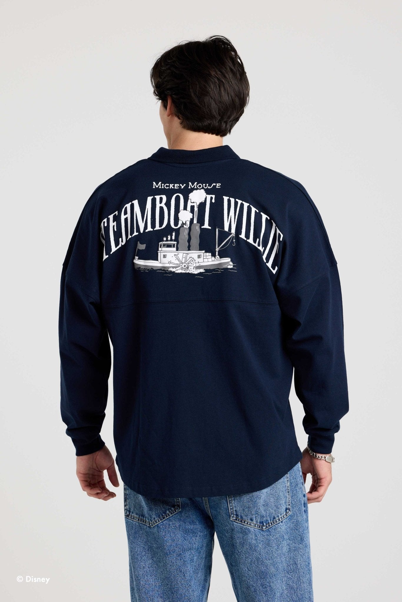 Back of the navy Steamboat Willie collared Spirit Jersey on a second model