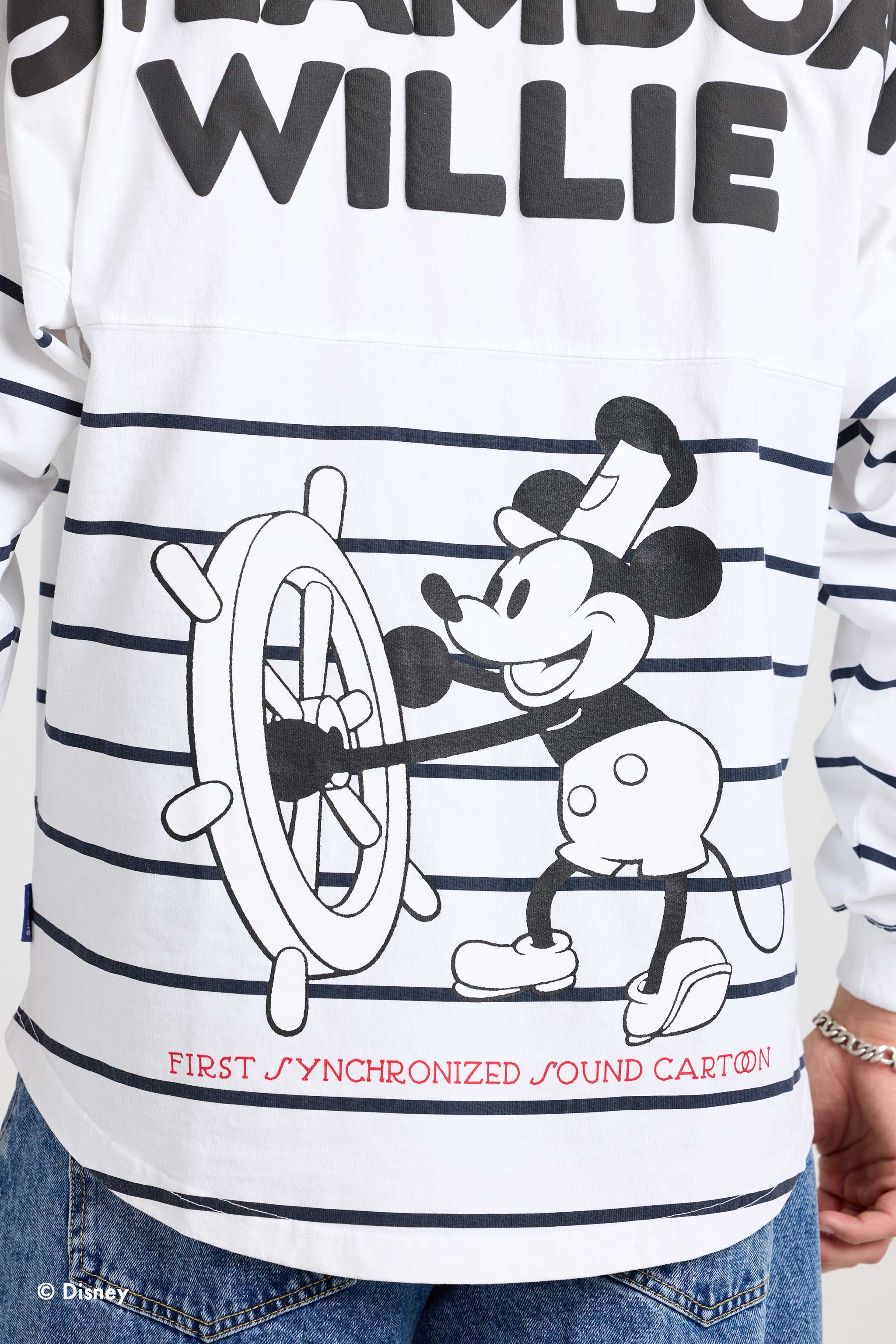 Close view of Mickey Mouse steering the boat on the striped Spirit Jersey