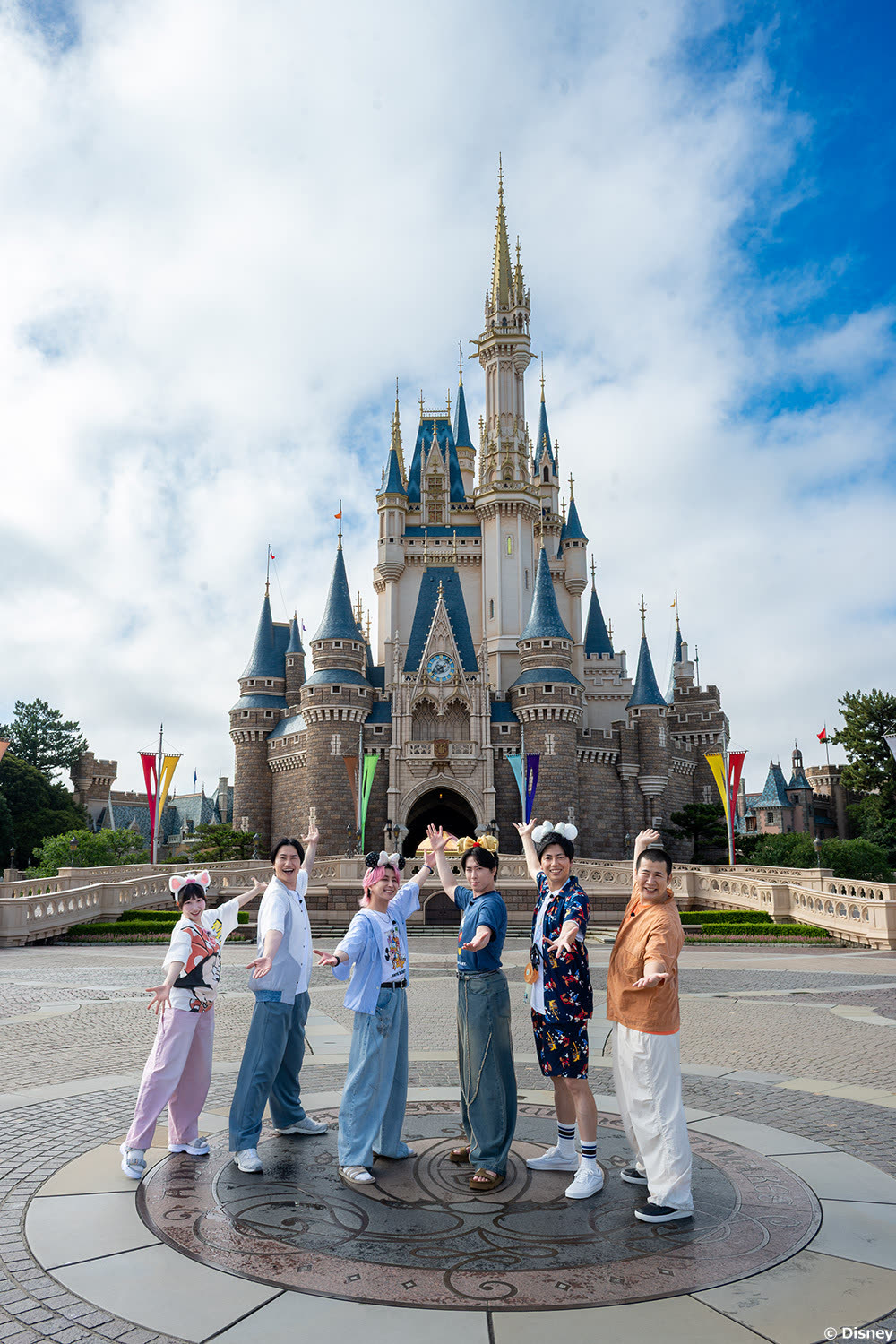 Love It! presenters and guests in front of Cinderella Castle at Tokyo Disneyland