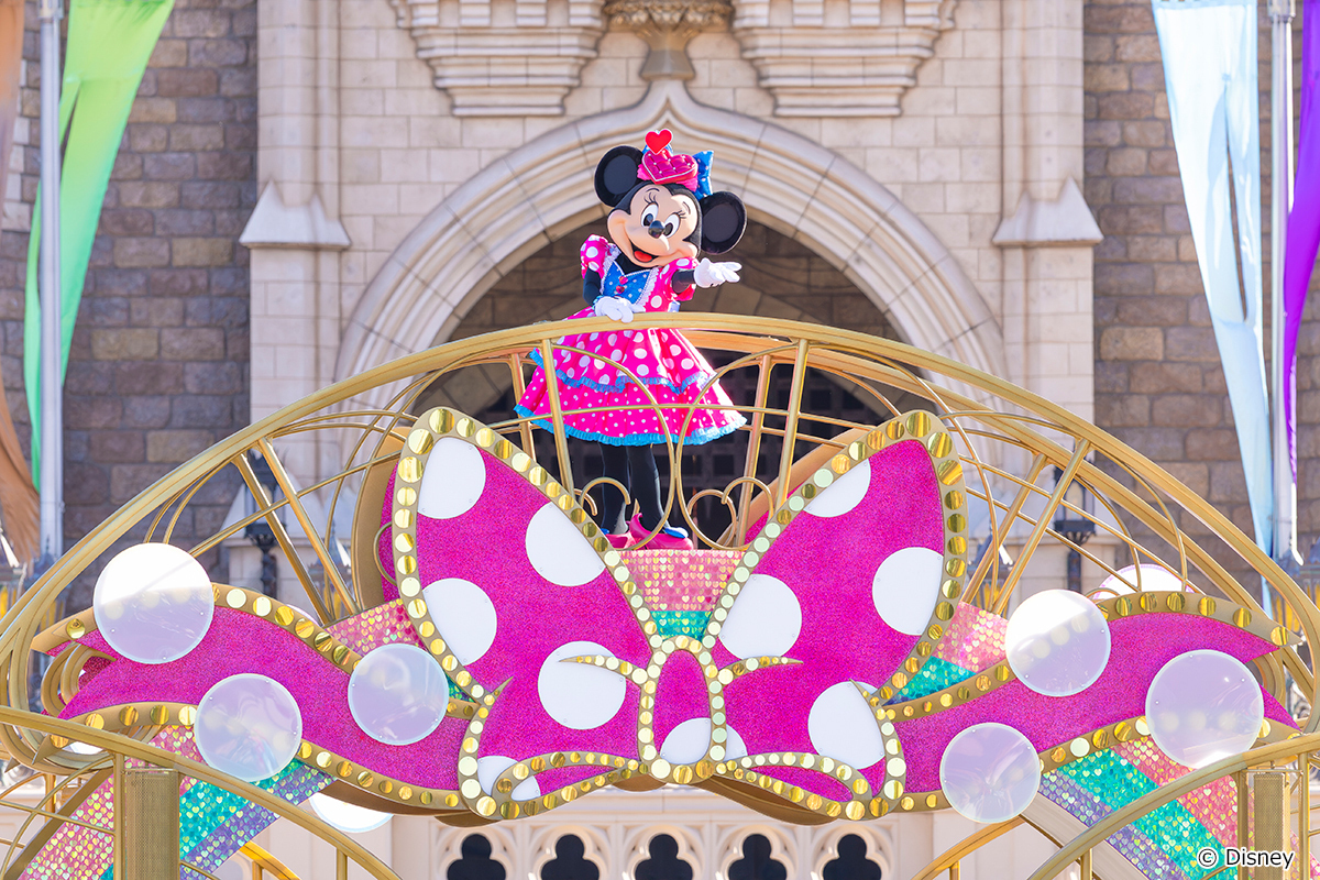 Minnie Mouse aboard a pink parade float at Tokyo Disneyland