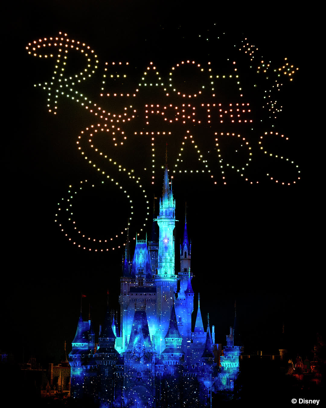 Reach for the Stars drone lettering above Cinderella Castle at Tokyo Disneyland